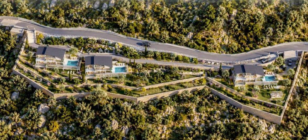 View from above of the whole site: the road along the top, villas 2 and 3 together on the left and villa 1 on its own on the right.